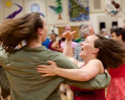 Happy dancers swinging so fast their hair is flying