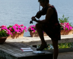 A fiddler practicing a tune outside