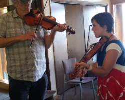 Two talented fiddlers working on a tune