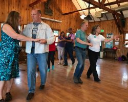 Two couples participating in a waltz workshop